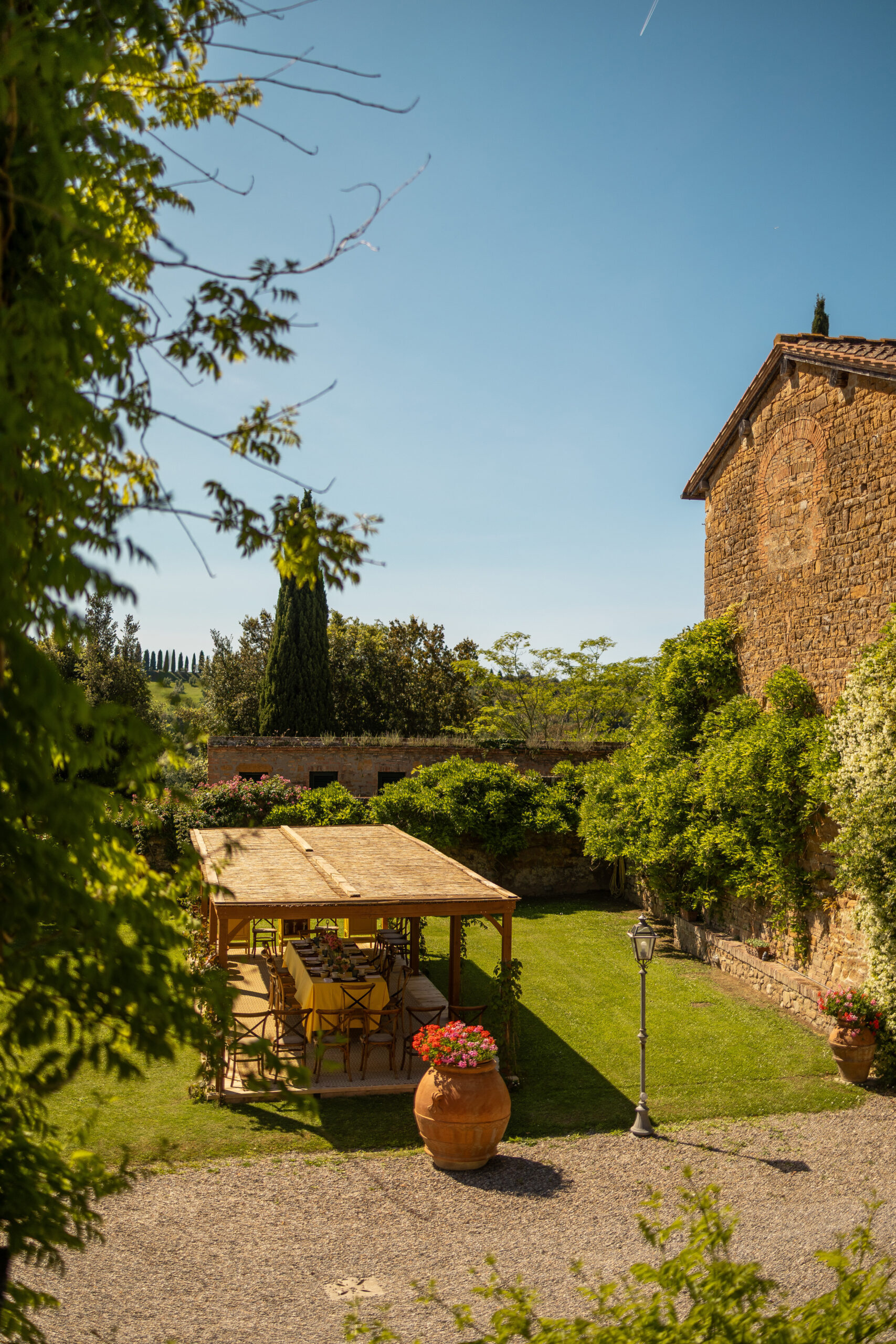 Exterior of Villa Piaggia: pergola, stone tower and manicured garden