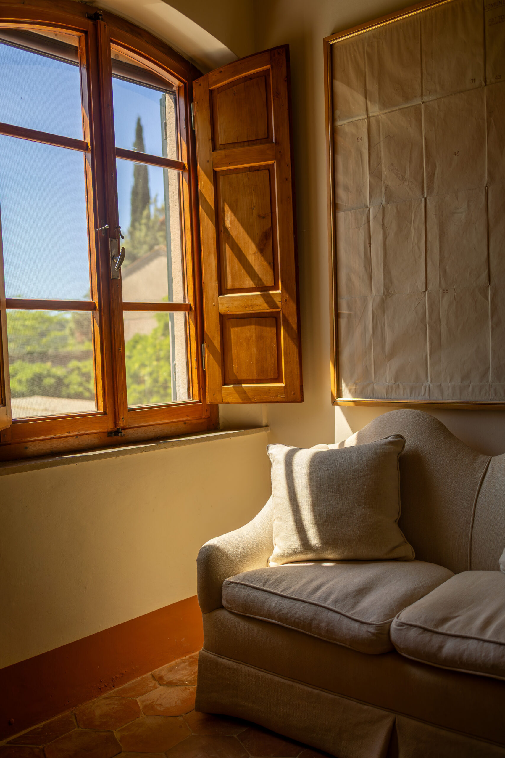 Living corner at Villa Piaggia with a light sofa and warm window light